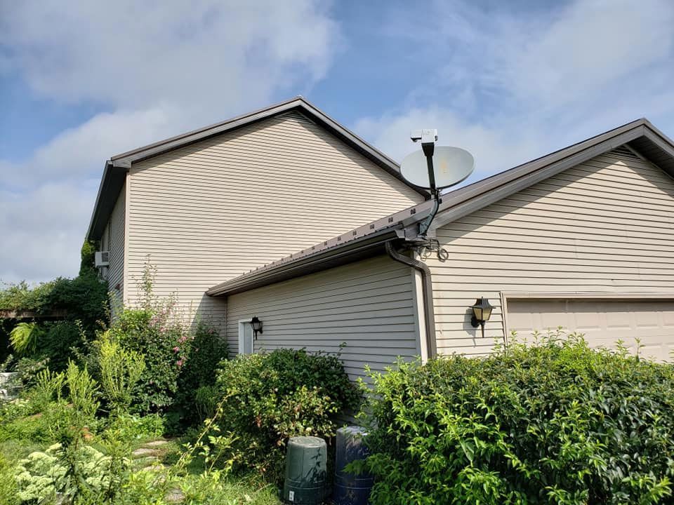 A house with a satellite dish on the side of it.