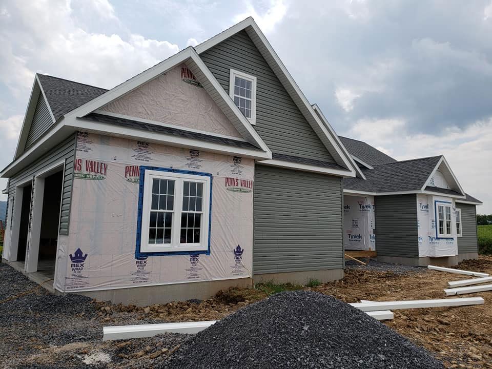 A house that is being built with a lot of rocks in front of it