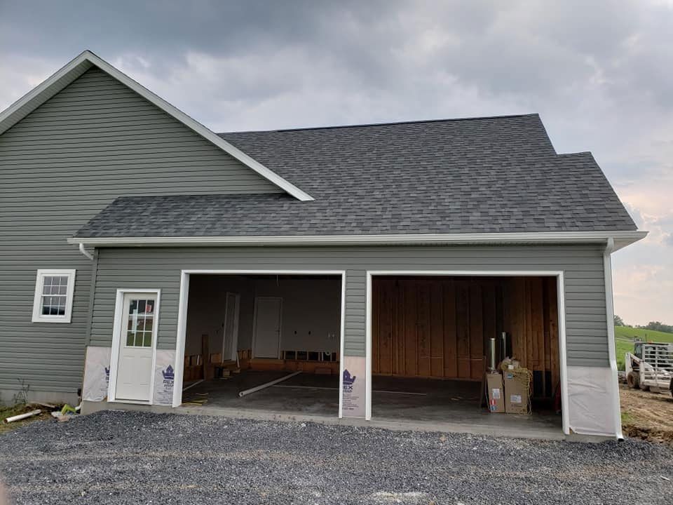 A house with a garage underneath it is being built.
