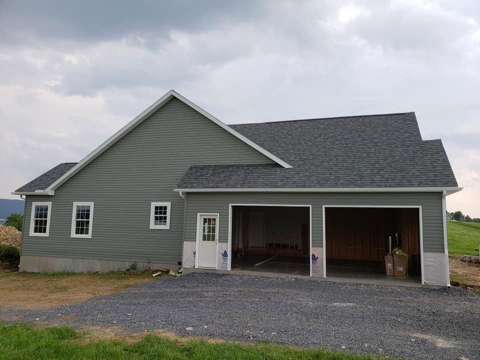 A house with a garage and a driveway in front of it