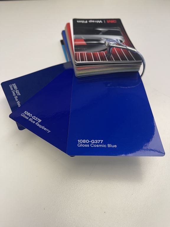 Blue paint color swatch fan with a car photo card on top, labeled “1000-0207 Classic Cobalt Blue.”