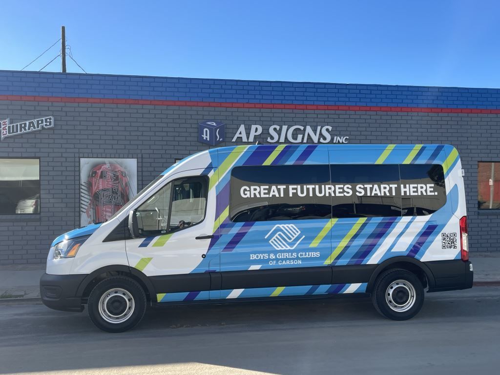 White AP Signs van with blue and green stripes parked by a building, reading Great futures start here.