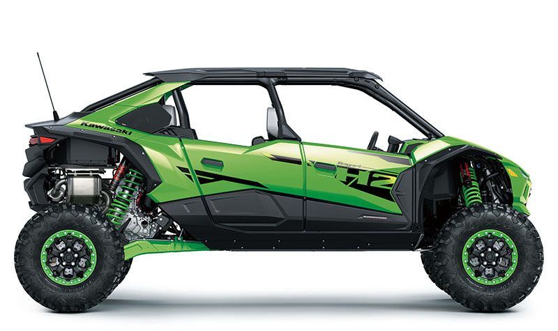 Green and black off-road buggy with exposed suspension and large tires, side view on white background