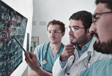 Young-male-doctors-looking-attentively-at-x-ray