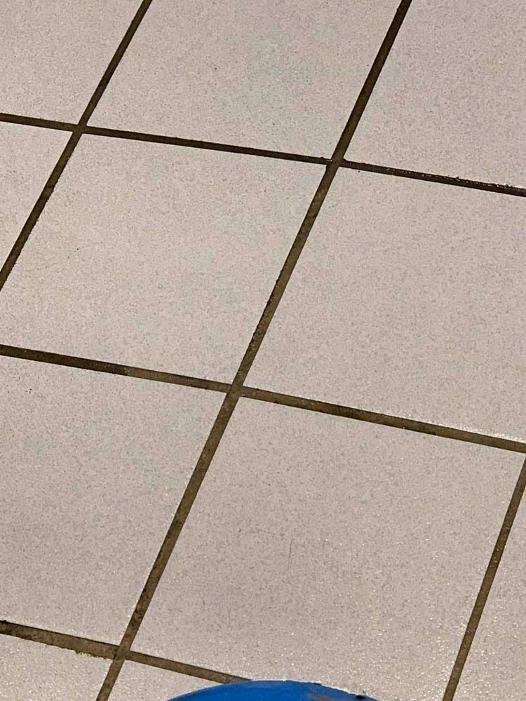 White tile floor with dark grout.