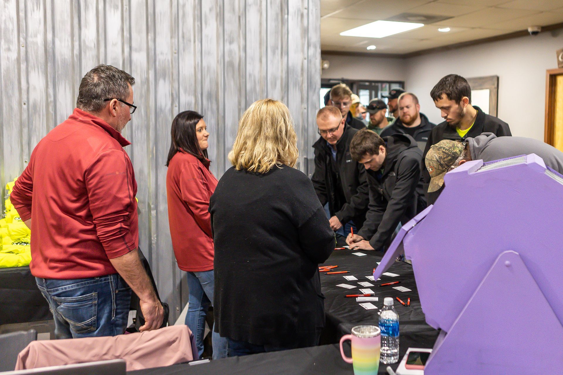 A group of people are standing around a table playing a game.