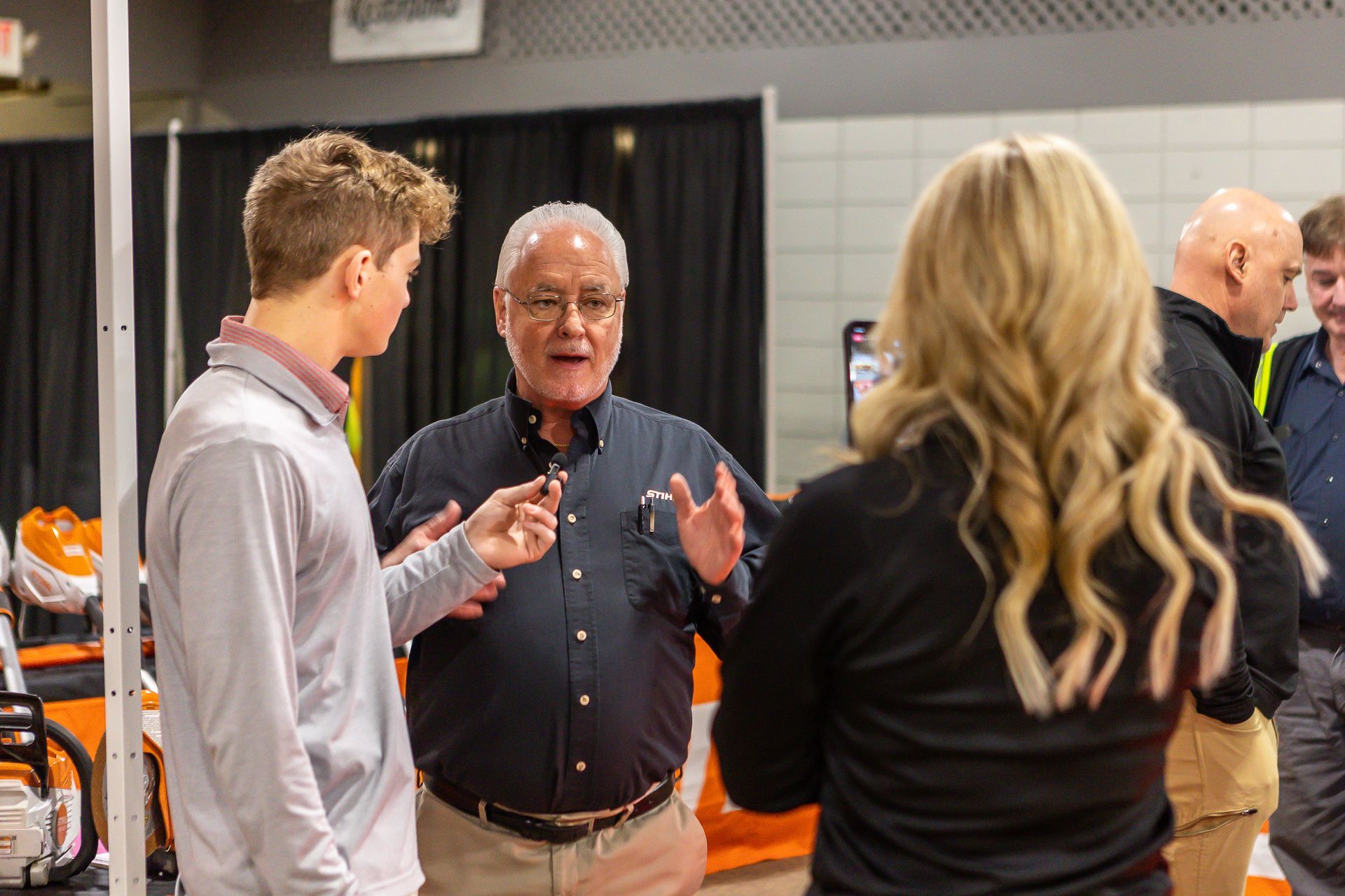 A group of people are talking to each other in a room.
