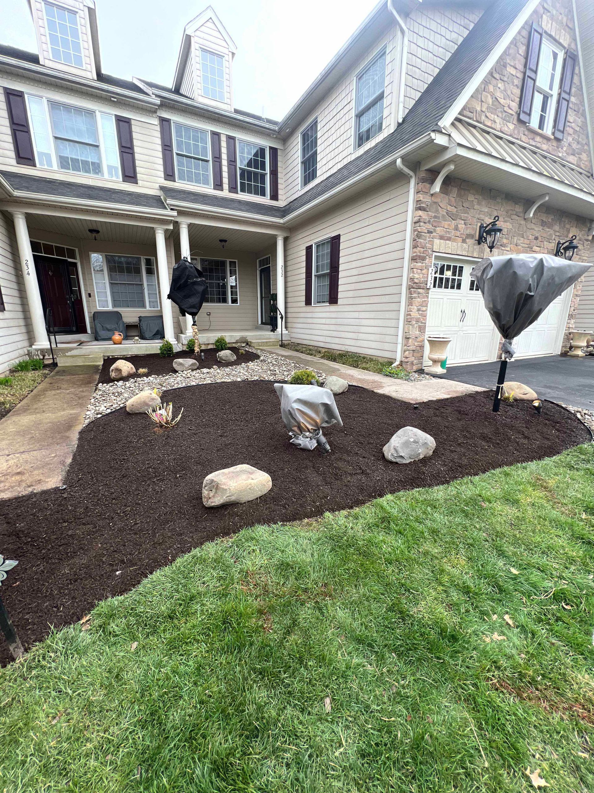 A large house with a lush green lawn in front of it.
