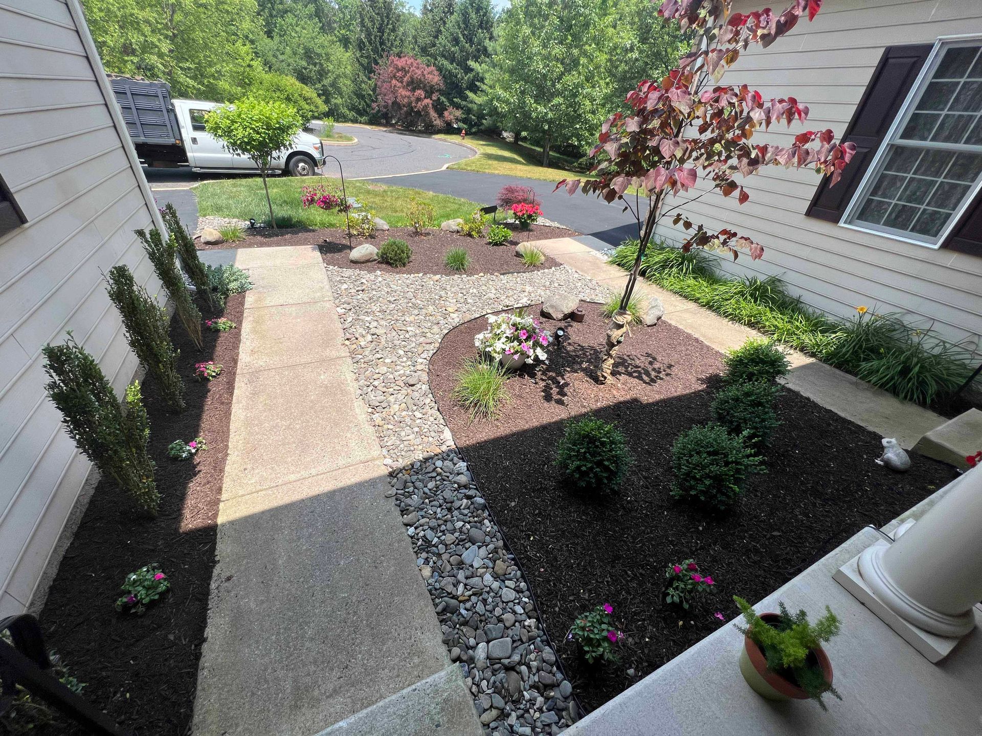 A white van is parked in the driveway of a house.