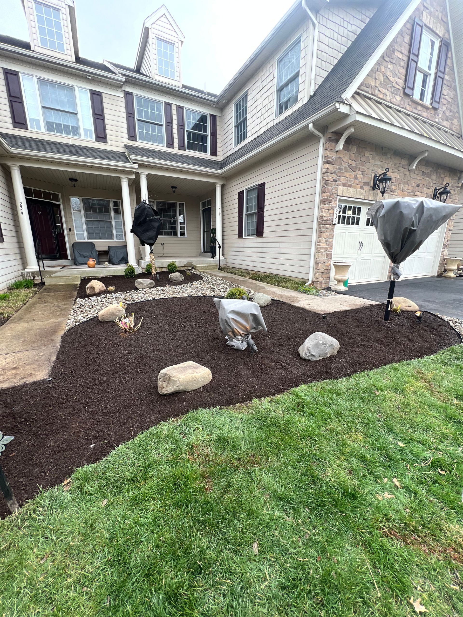A large house with a lush green lawn in front of it.