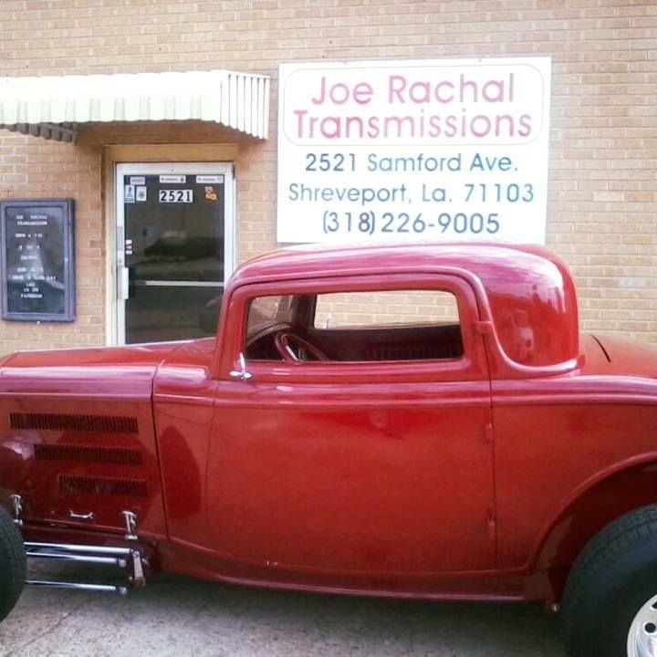 A red car is parked in front of joe rachal transmissions