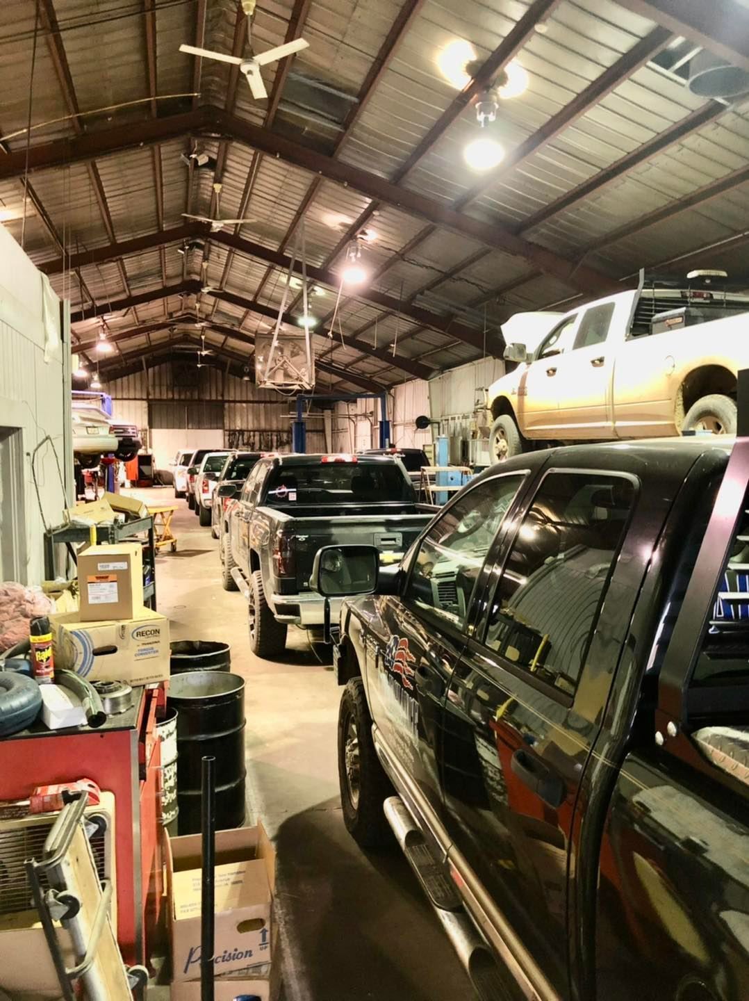 A lot of trucks are parked in a garage.