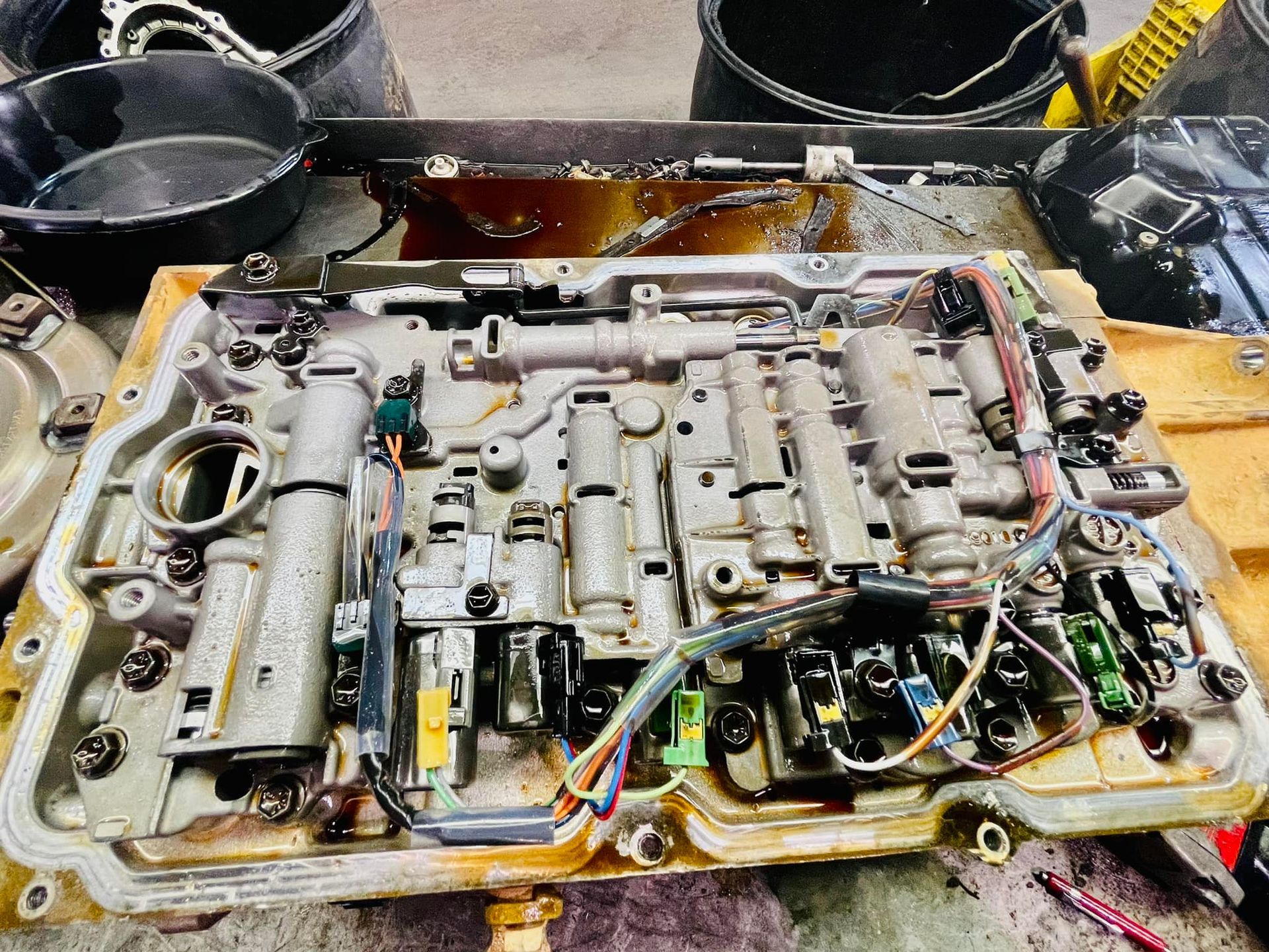 A close up of a gearbox with a lot of wires coming out of it.