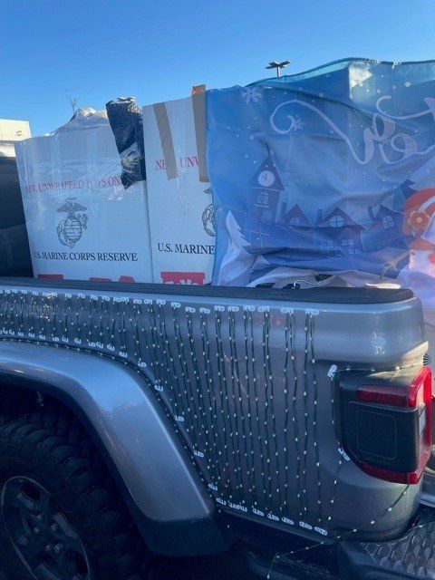 Truck bed filled with boxes and bags for a U.S. Marine Corps Reserve toy drive.