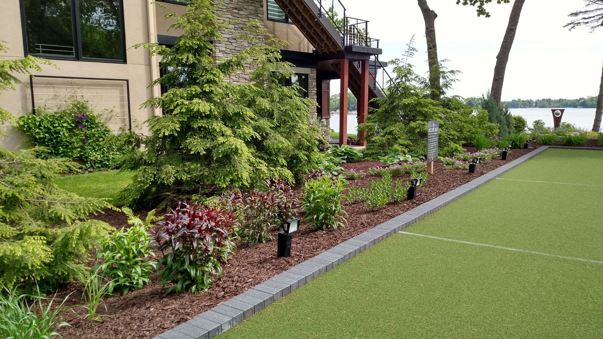 A large house with a lush green lawn in front of it.