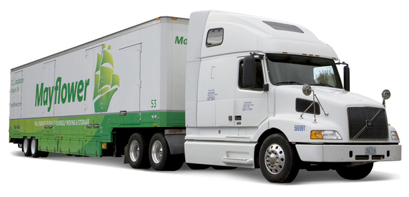 White semi-truck with green trailer carrying the “MyMover” logo on a plain background