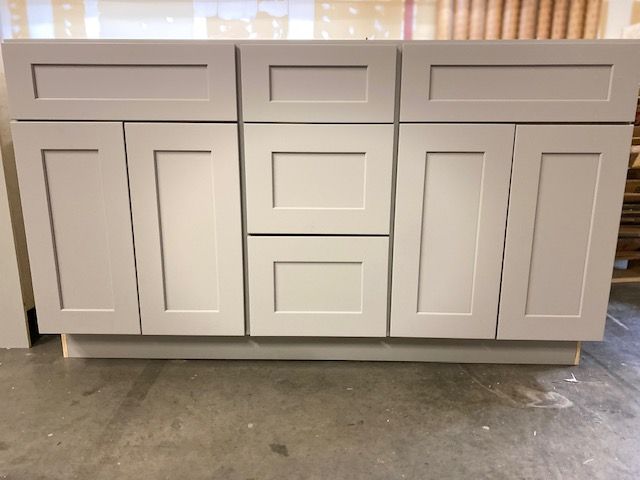 Gray bathroom vanity with six doors and two drawers.