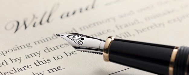 last will and testament document with closeup on fountain pen with signature line