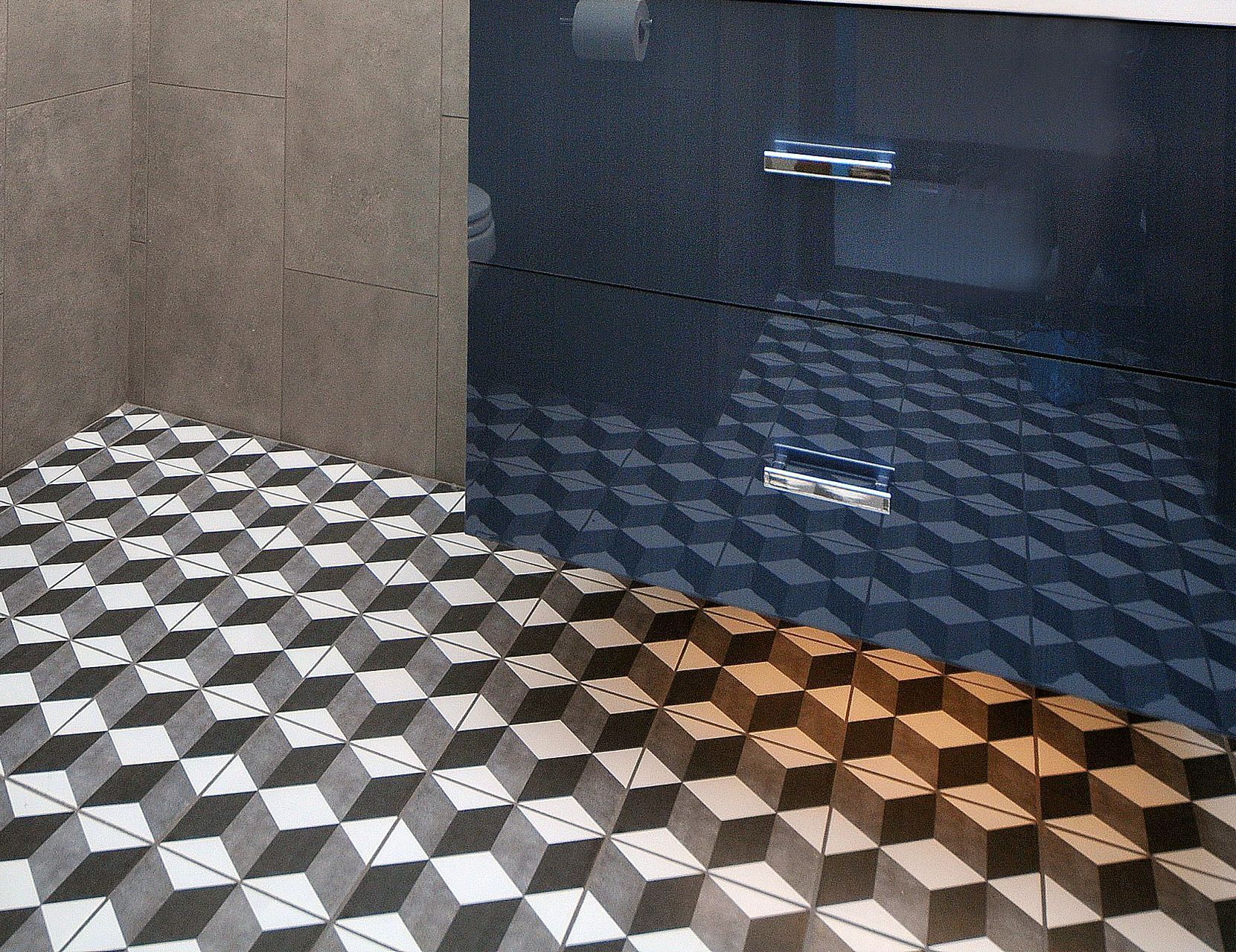 Geometric black-and-white tiled floor beside a dark cabinet with silver handles