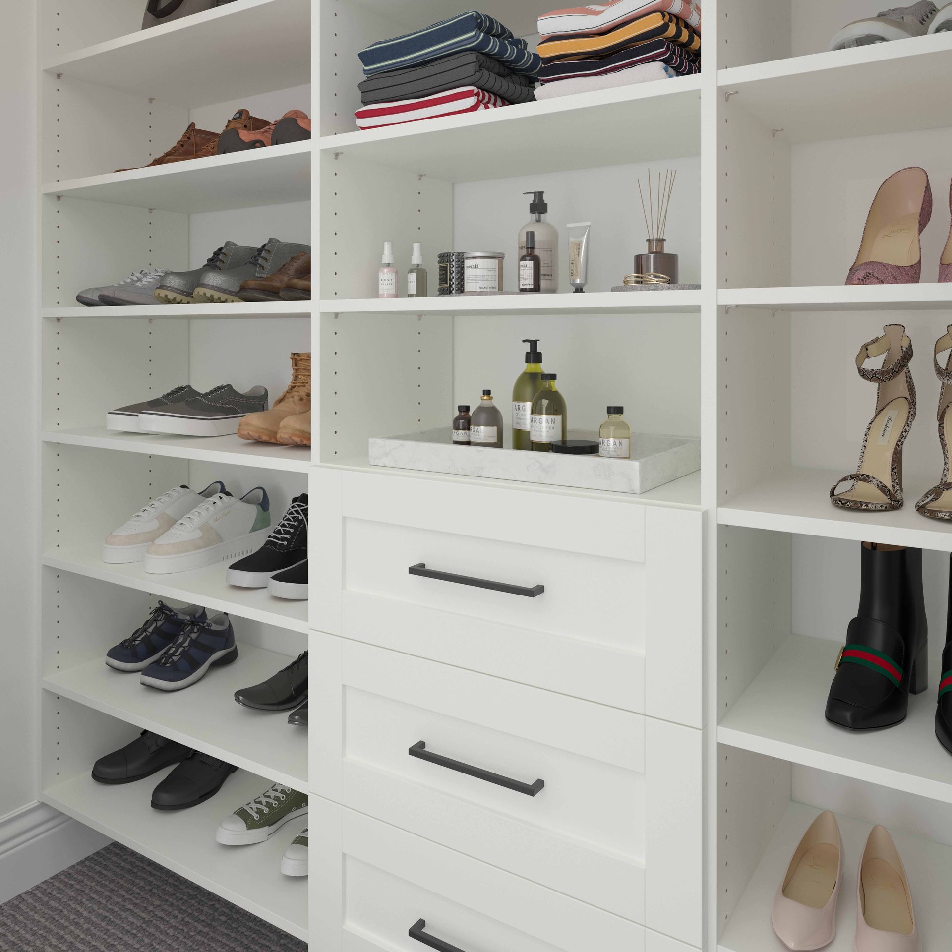 White closet with shelves of folded clothes, shoes, perfume, and drawer storage.
