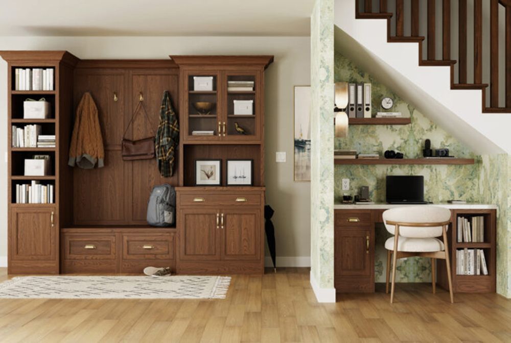Wood-paneled entryway with built-in storage, a desk nook, and stairs in a warm, minimalist home interior