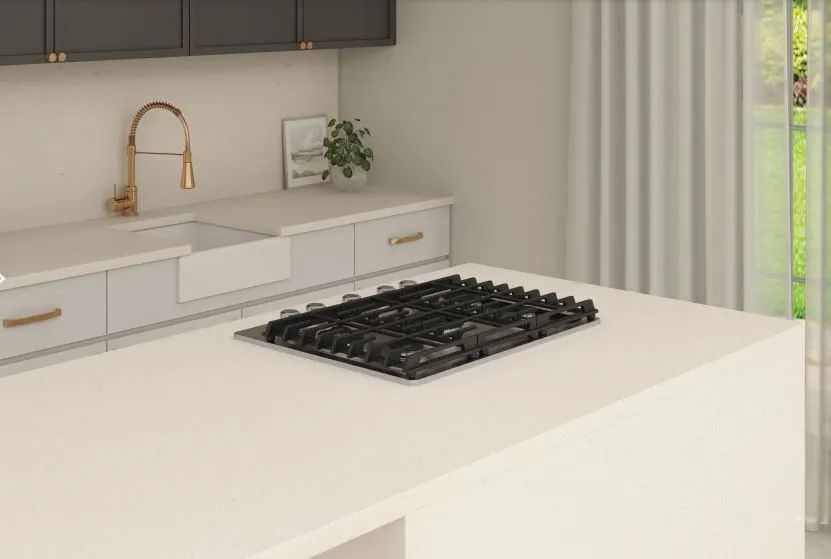 Minimal white kitchen with a black stovetop and gold faucet near a window