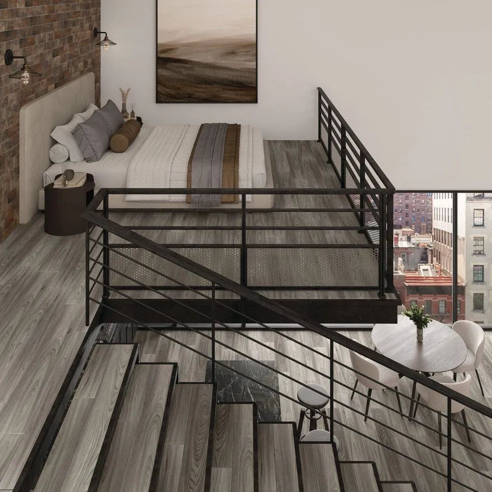 Modern loft bedroom with bed, black metal railing, wood stairs, and city view through large window.