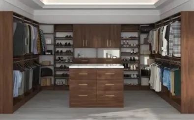 Walk-in closet with wooden shelves, hanging clothes, and a central dresser under a coffered ceiling