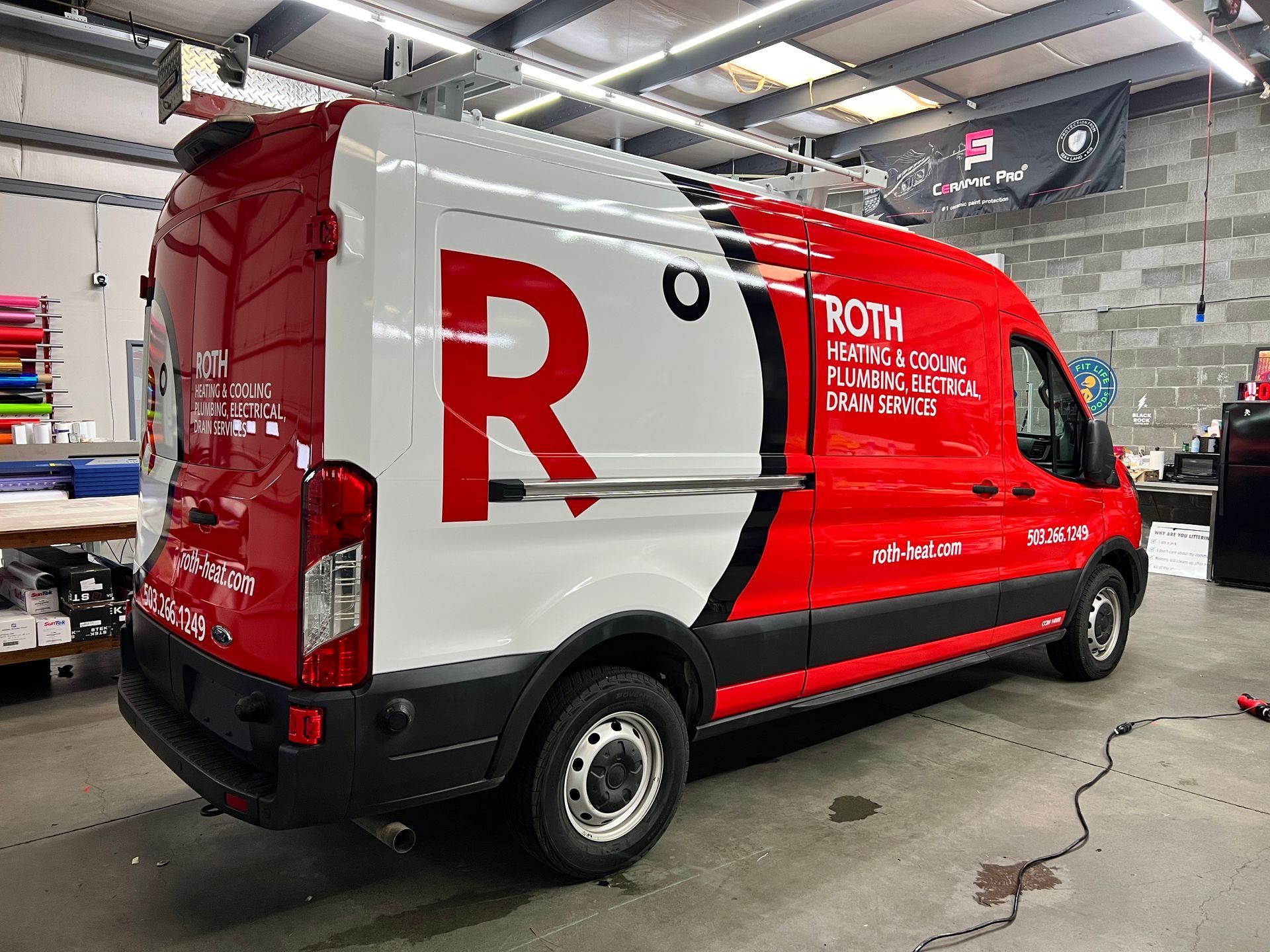 Red and white van with "ROTH" logo, parked in an indoor facility.