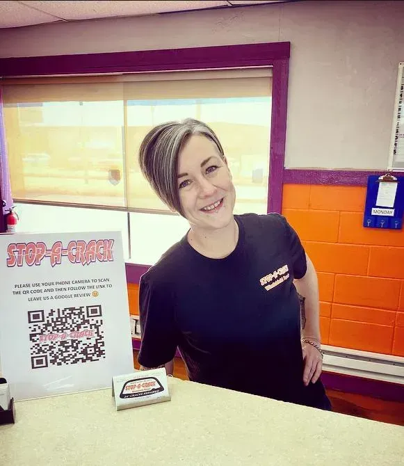 Woman smiling behind a counter at 