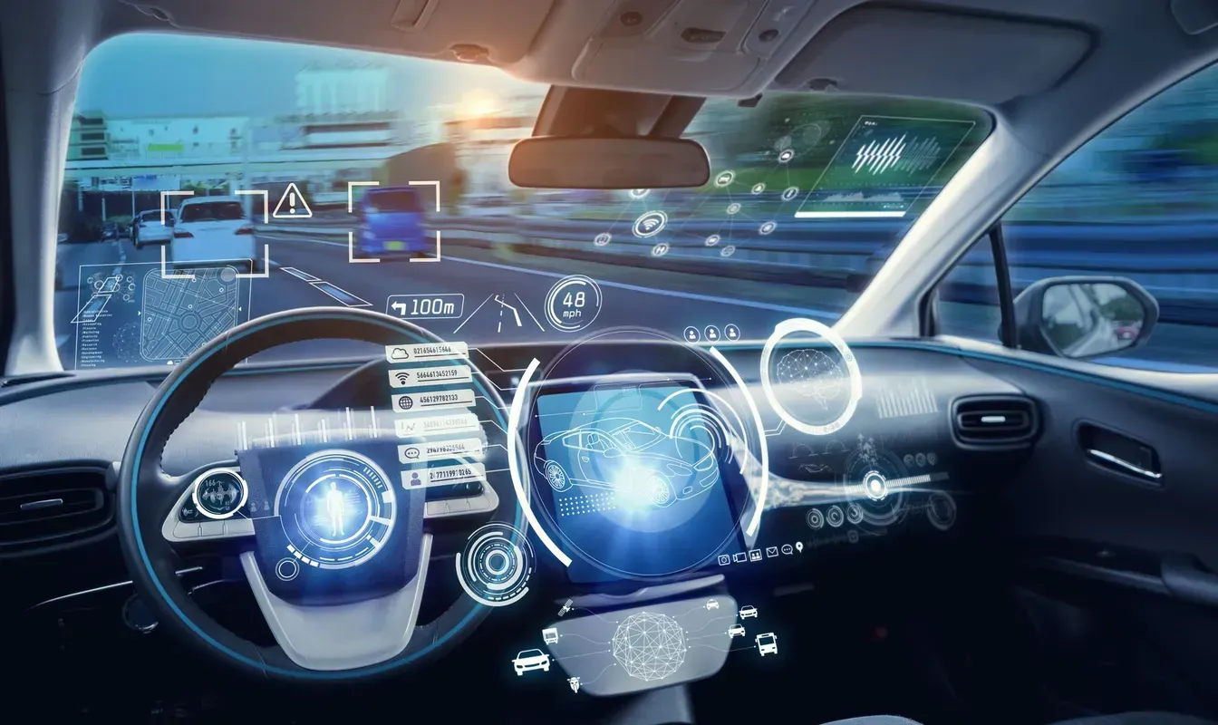 Interior of self-driving car with digital interface showing road, speed, and other vehicles.