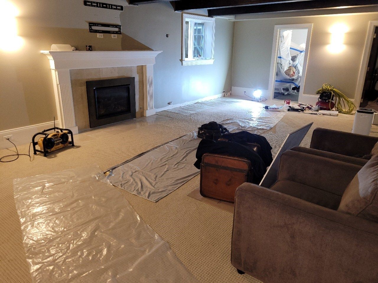 A living room with a fireplace and two chairs