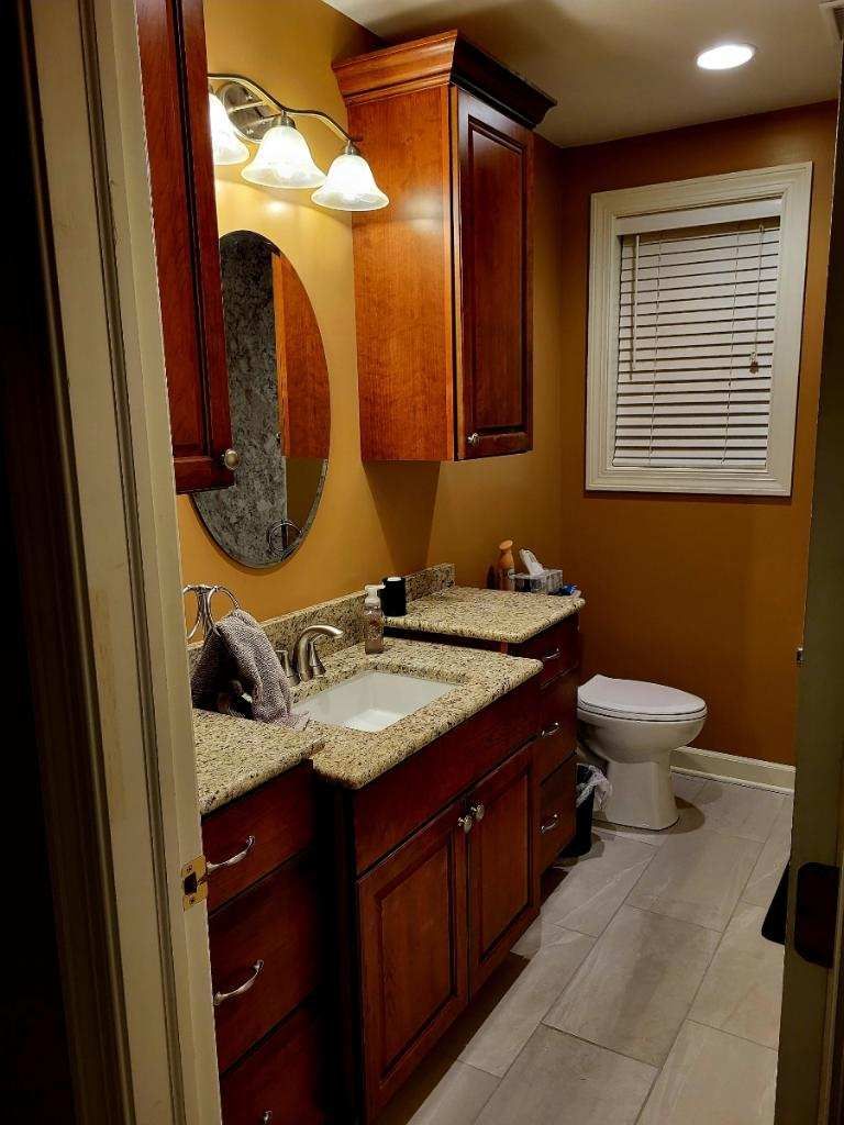 A bathroom with a sink, toilet and mirror