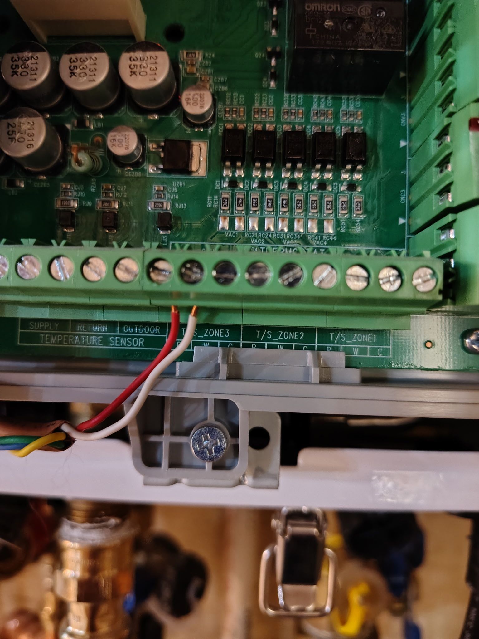 Electronic circuit board with wires connected to terminal blocks.