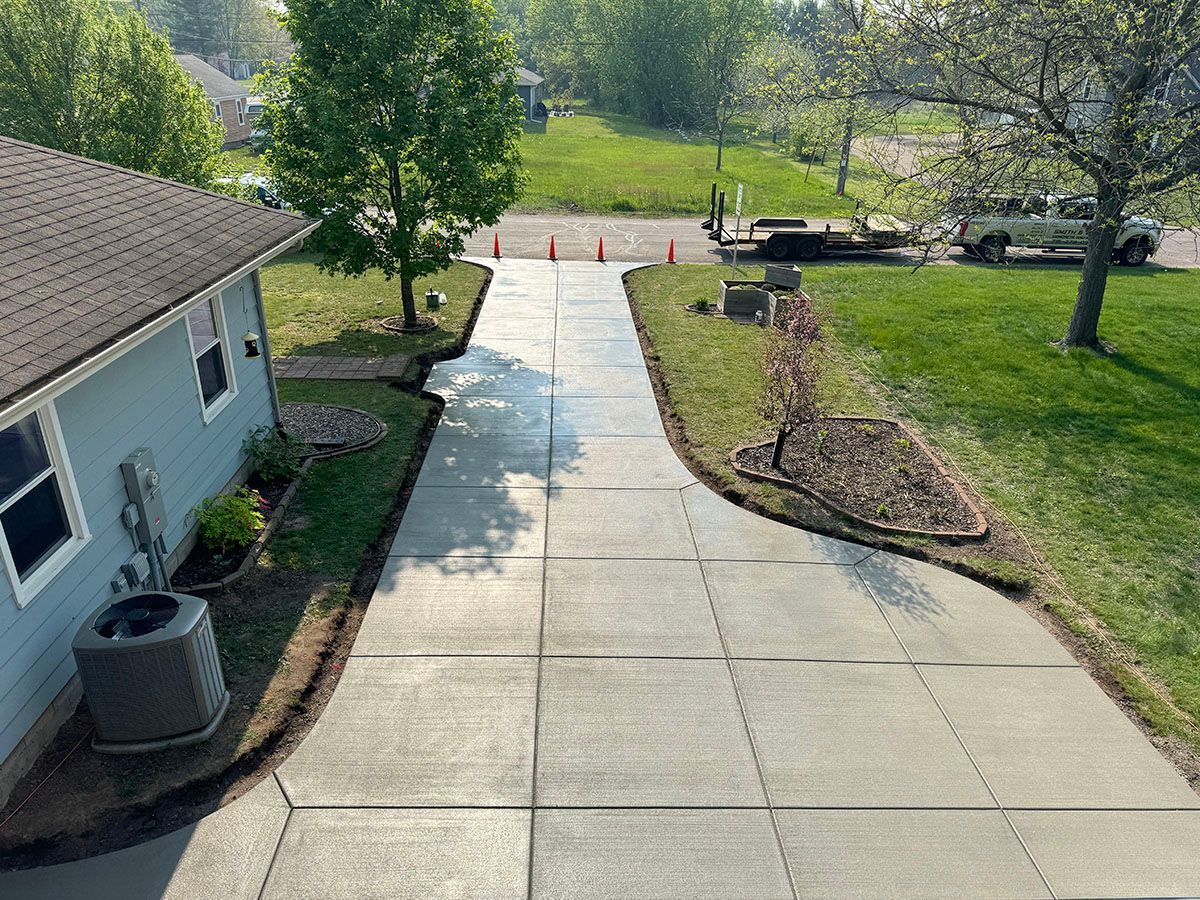 A concrete driveway leading to a house