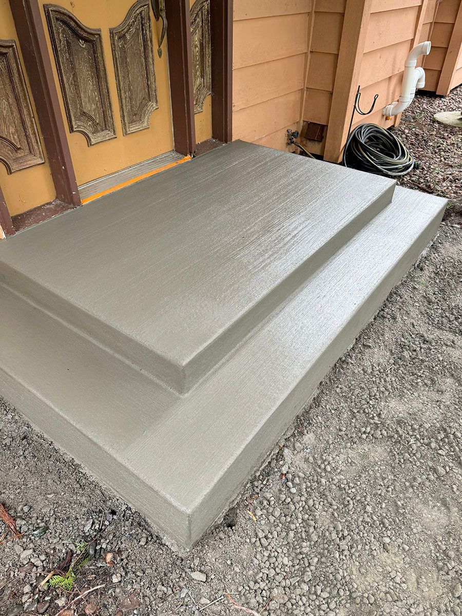 A set of concrete steps leading up to a house