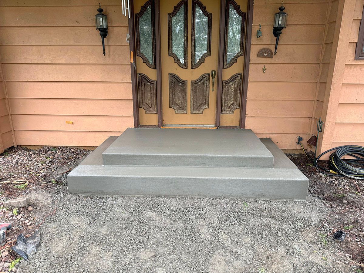 A house with concrete steps leading up to the front door