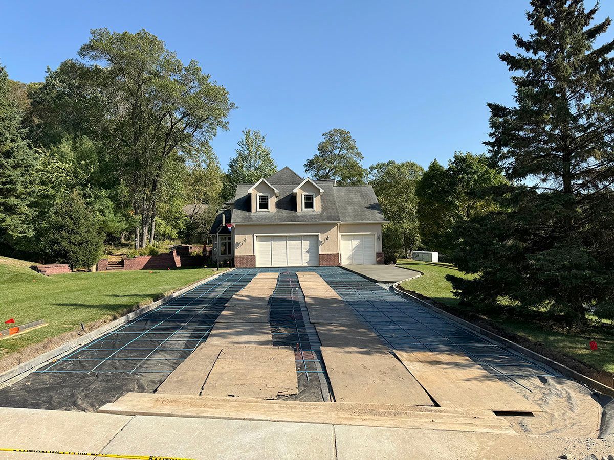 A new driveway is being built in front of a house