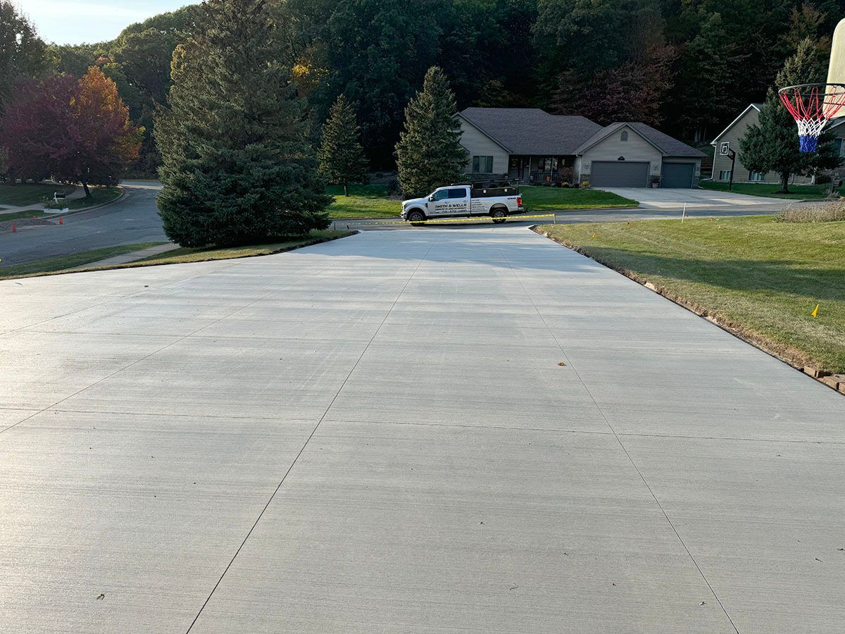 A white truck is parked in a driveway next to a house