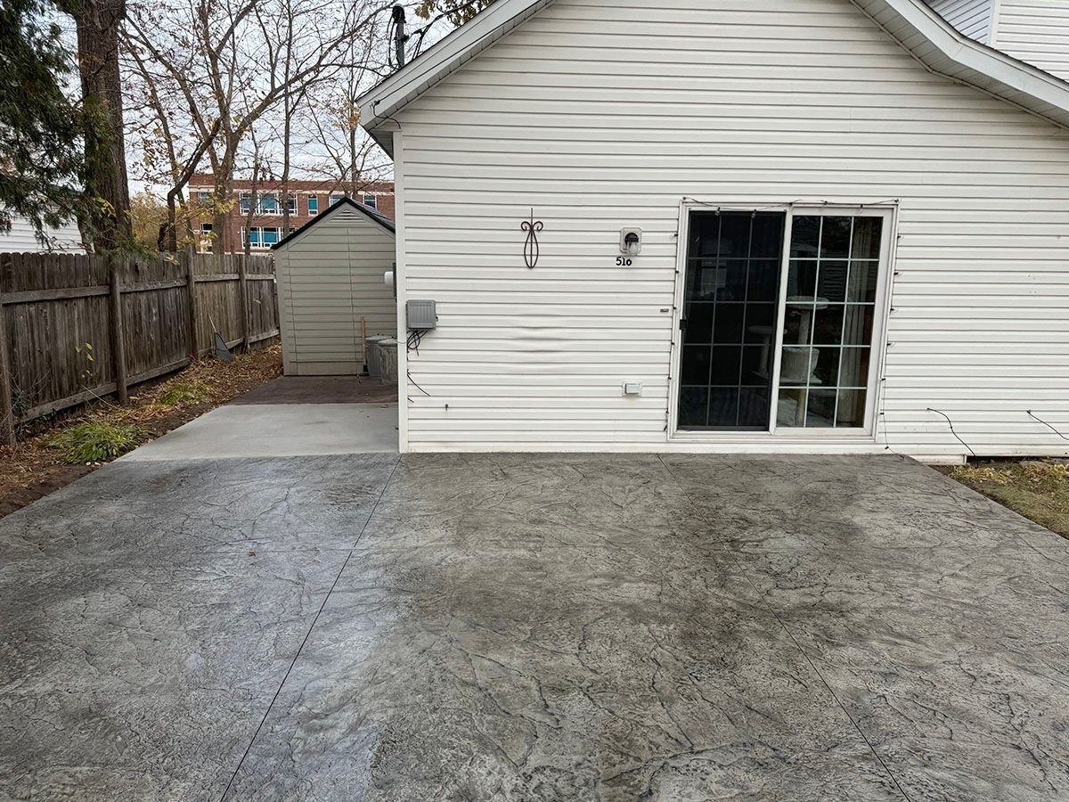 A white house with a concrete walkway in front of it