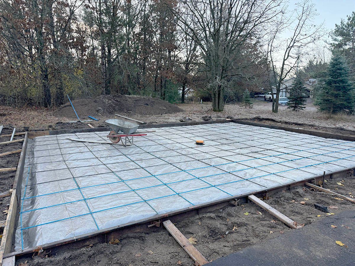 A wheelbarrow is sitting on top of a concrete slab