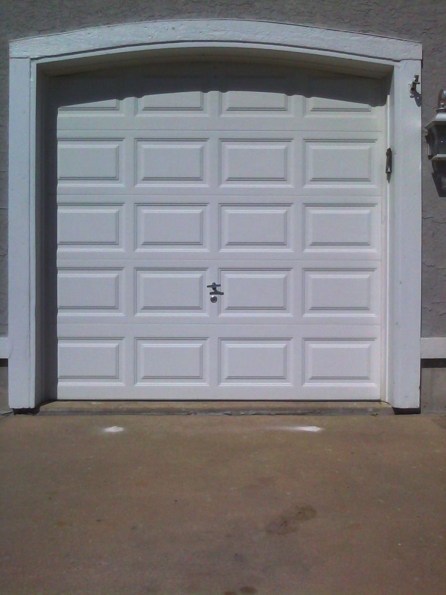 A white garage door with squares on it