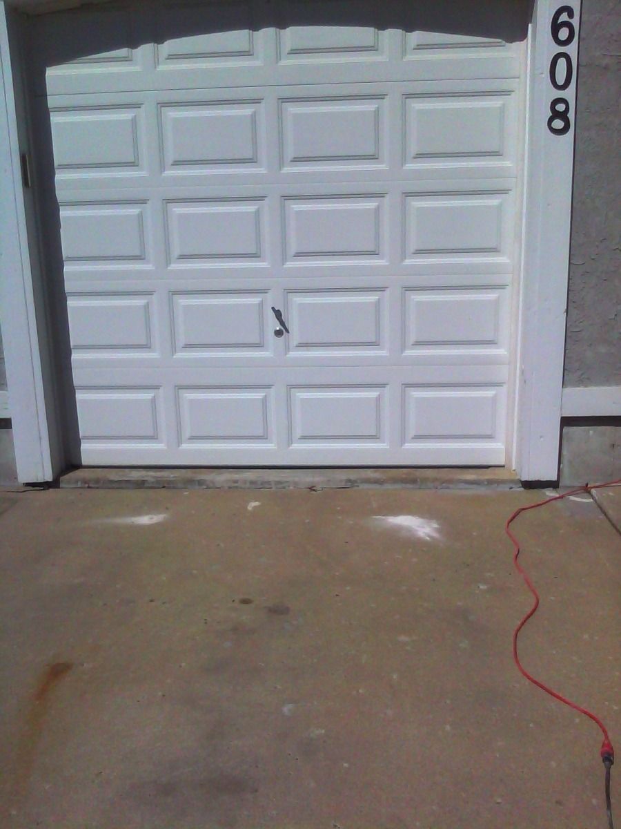 A white garage door with the number 608 on it