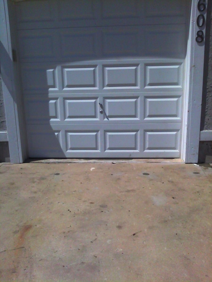 A white garage door with the number 6006 on it