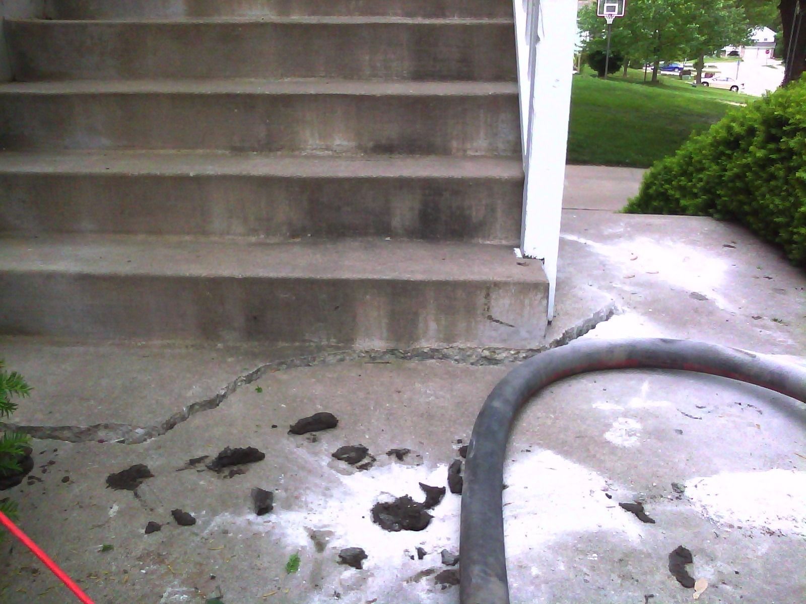 A concrete staircase with a red hose in front of it