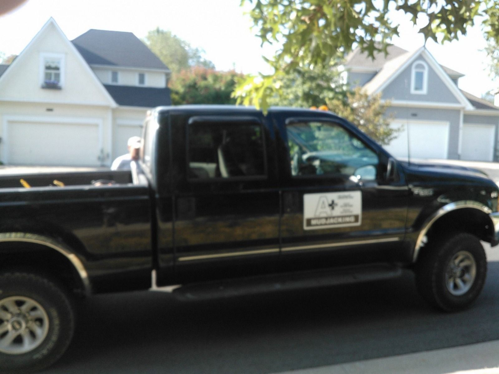 A black truck is parked on the side of the road