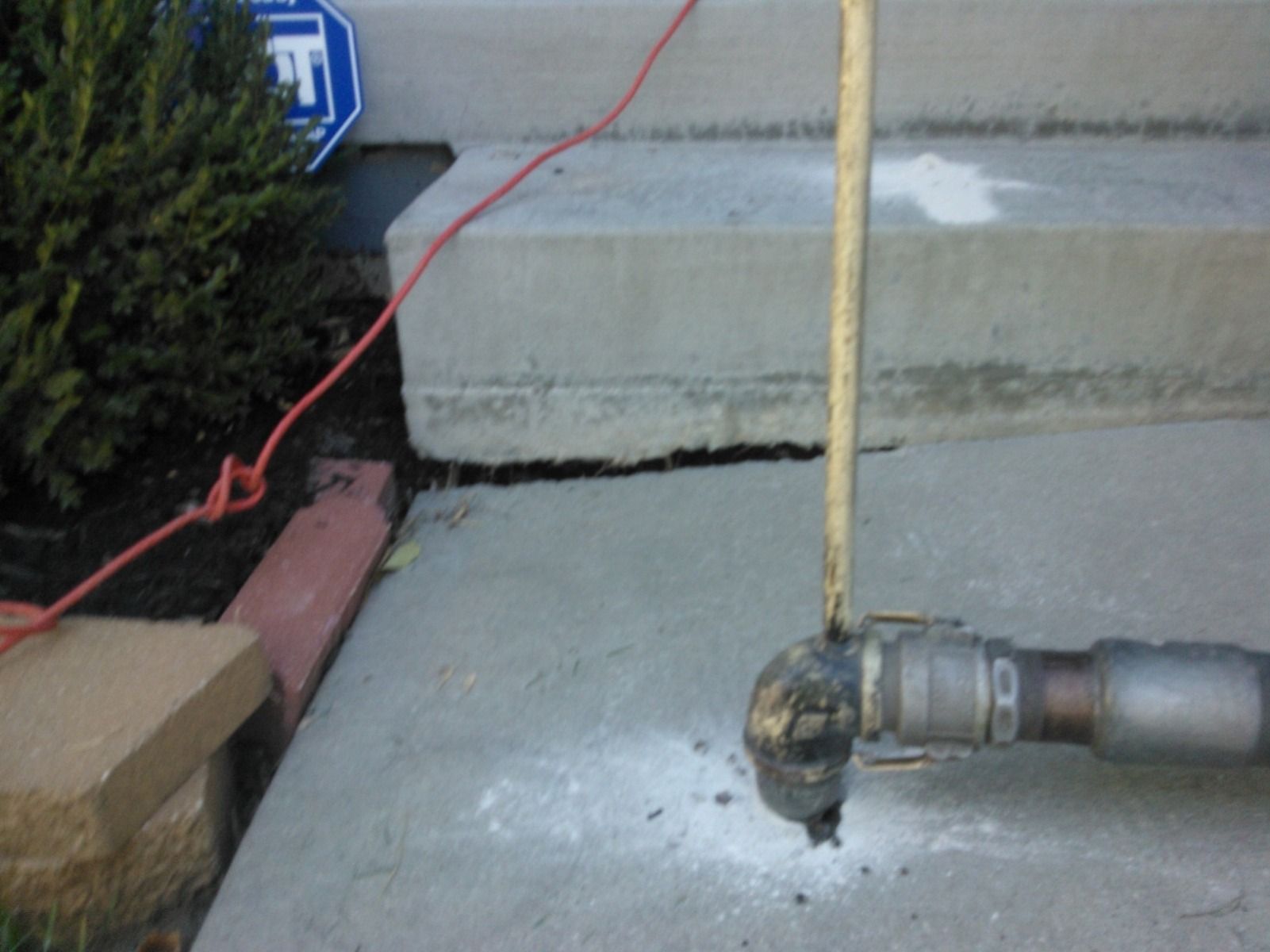 A concrete sidewalk with a sign that says f on it