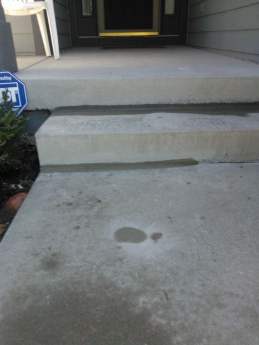 A concrete walkway with steps and a sign that says no parking