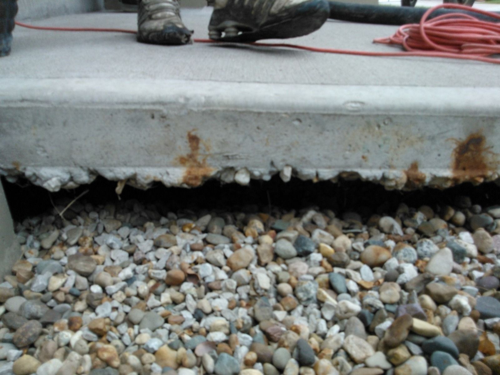 A person is standing next to a pile of rocks