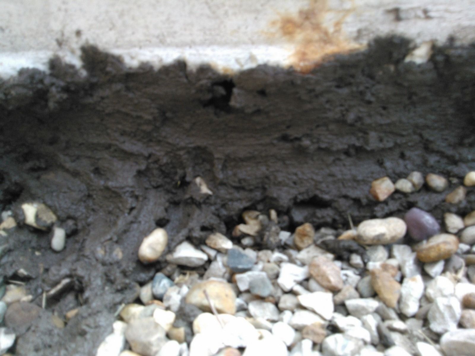 A pile of rocks and a pile of dirt on the ground